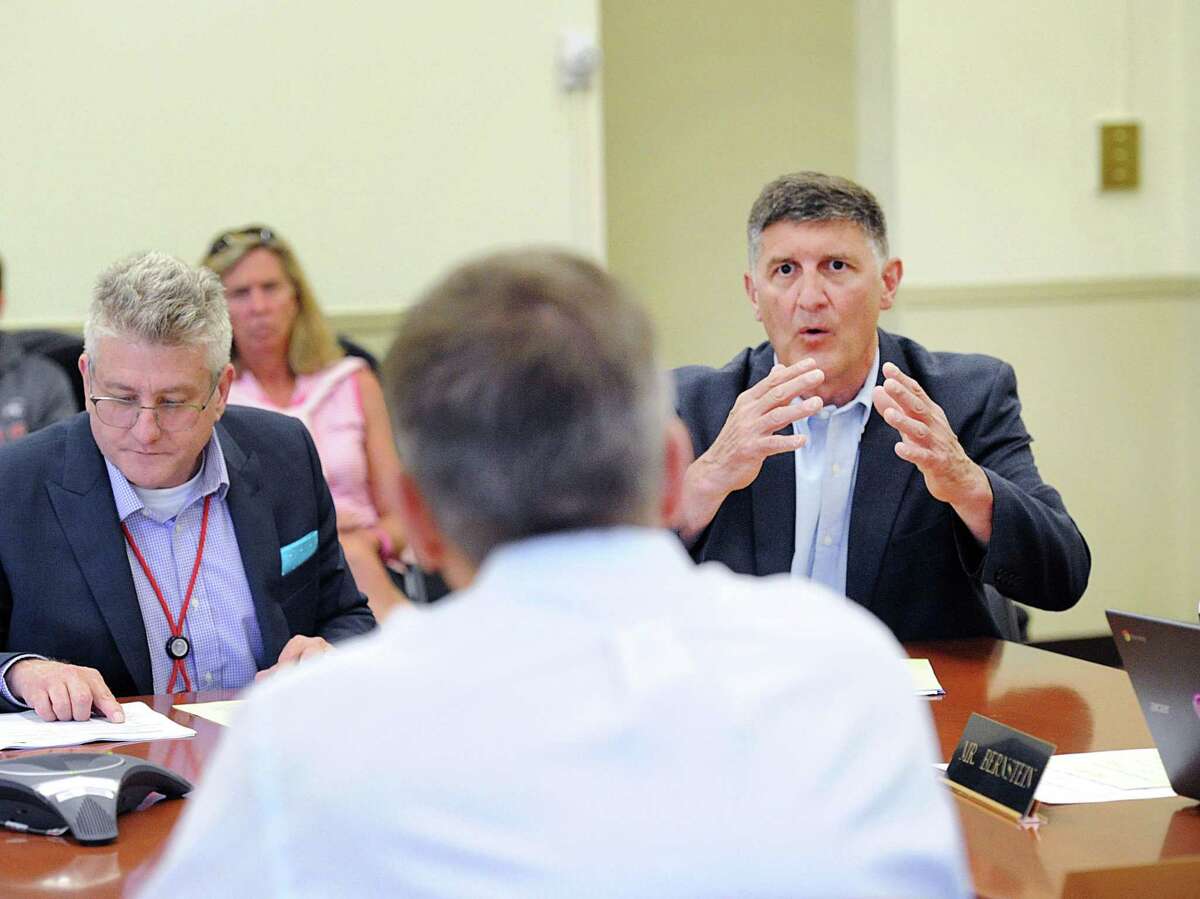 At right, Greenwich High School Athletic Director Gus Lindine speaks during the Greenwich Board of Education meeting in which money donated by the Greenwich Athletic Foundation to provide new bleachers for the Greenwich High School gym was accepted and approved by the board at the Havemeyer Building in Greenwich, Conn., Thursday, July 13, 2017. The Greenwich Athletic Foundation is new group whose mission is to support Greenwich public school athletics and its facilities.