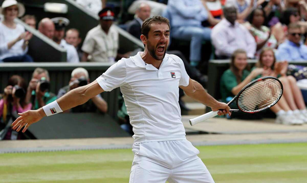 Croatia's Marin Cilic celebrates after beating Sam Querrey of the United States at the end of their Men's Singles semifinal match on day eleven at the Wimbledon Tennis Championships in London, Friday, July 14, 2017. (AP Photo/Kirsty Wigglesworth)