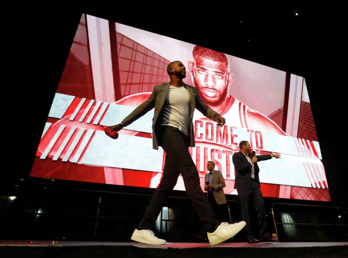 Chris Paul throws a t-shirt to the crowd after he was introduced to Houston Rockets fans at the Toyota Center, Friday, July, 14, 2017.