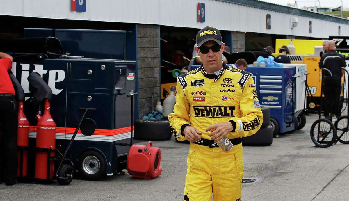 Matt Kenseth walks through the garage area after a NASCAR auto racing practice at the New Hampshire Motor Speedway in Loudon, N.H., Friday, July 14, 2017. Kenseth said Friday he has no hard feelings toward Joe Gibbs Racing after he was dumped by the team and has no concerns about his future, even though he has yet to land a job for 2018. (AP Photo/Charles Krupa)