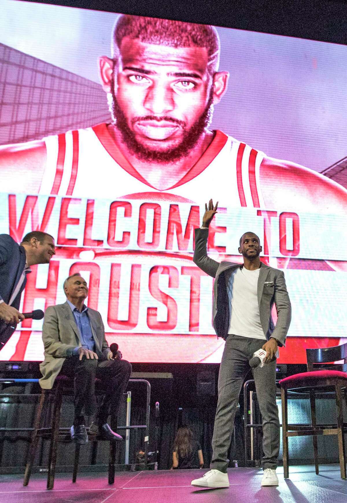 Chris Paul waves to fans after being introduced as the newest member of the Houston Rockets Friday, July 14, 2017, in Houston. The nine-time All-Star was traded from the Los Angeles Clippers late last month. (AP Photo/David J. Phillip)