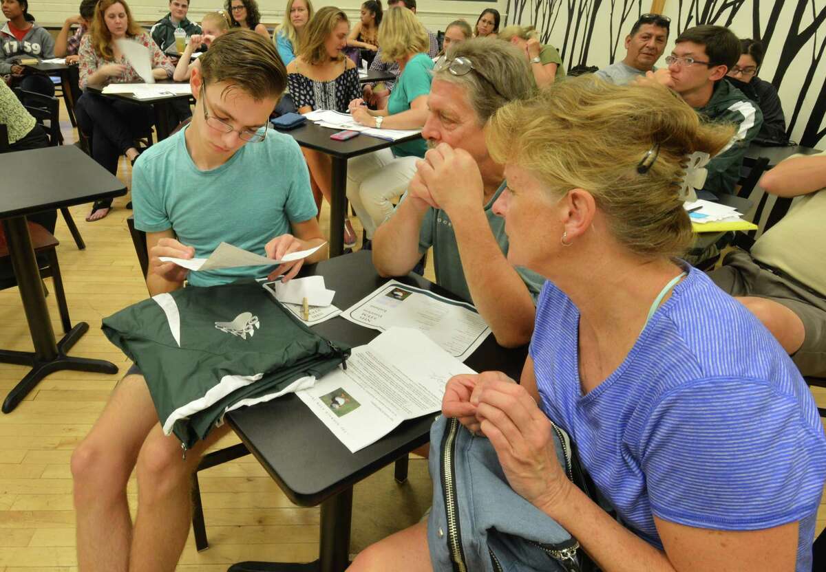 Bill and Jan Broome go over itinerary with their son William C. Broome during a meeting of the Norwalk High School STEM Travelers group as they get details of their upcoming trip to Iceland with organizer Caitlin Engle on Thursday July 13, 2017 in Norwalk Conn. The kids will explore the country and conduct research projects during the week long trip.