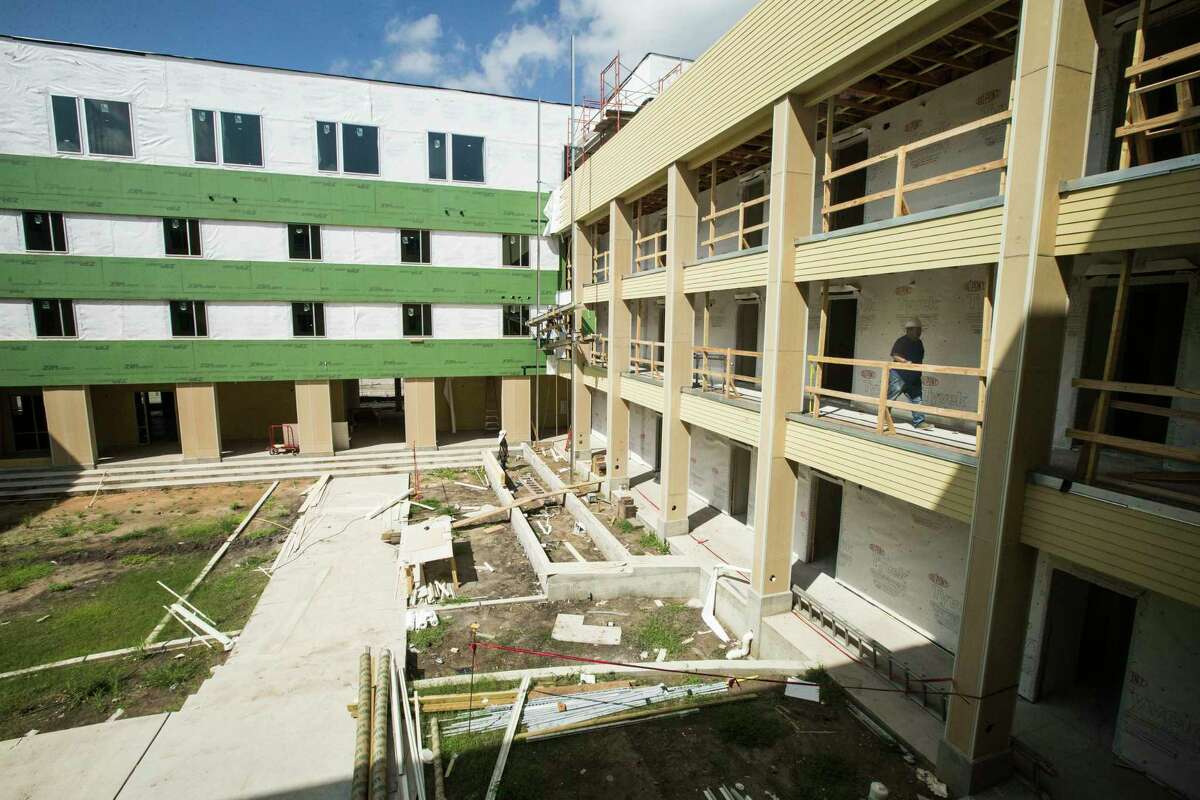 Construction workers build at New Hope Housing on Harrisburg on Friday, July 14, 2017, in Houston. The complex is being built through bond money slated for housing.