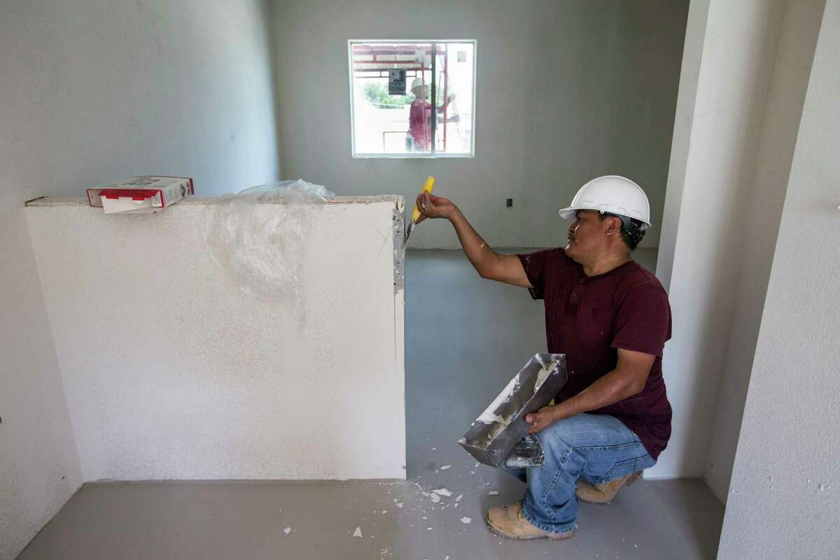 Manuel Cespedes works in one of the resident rooms at New Hope Housing on Harrisburg on Friday, July 14, 2017, in Houston. The complex is being built through bond money slated for housing.