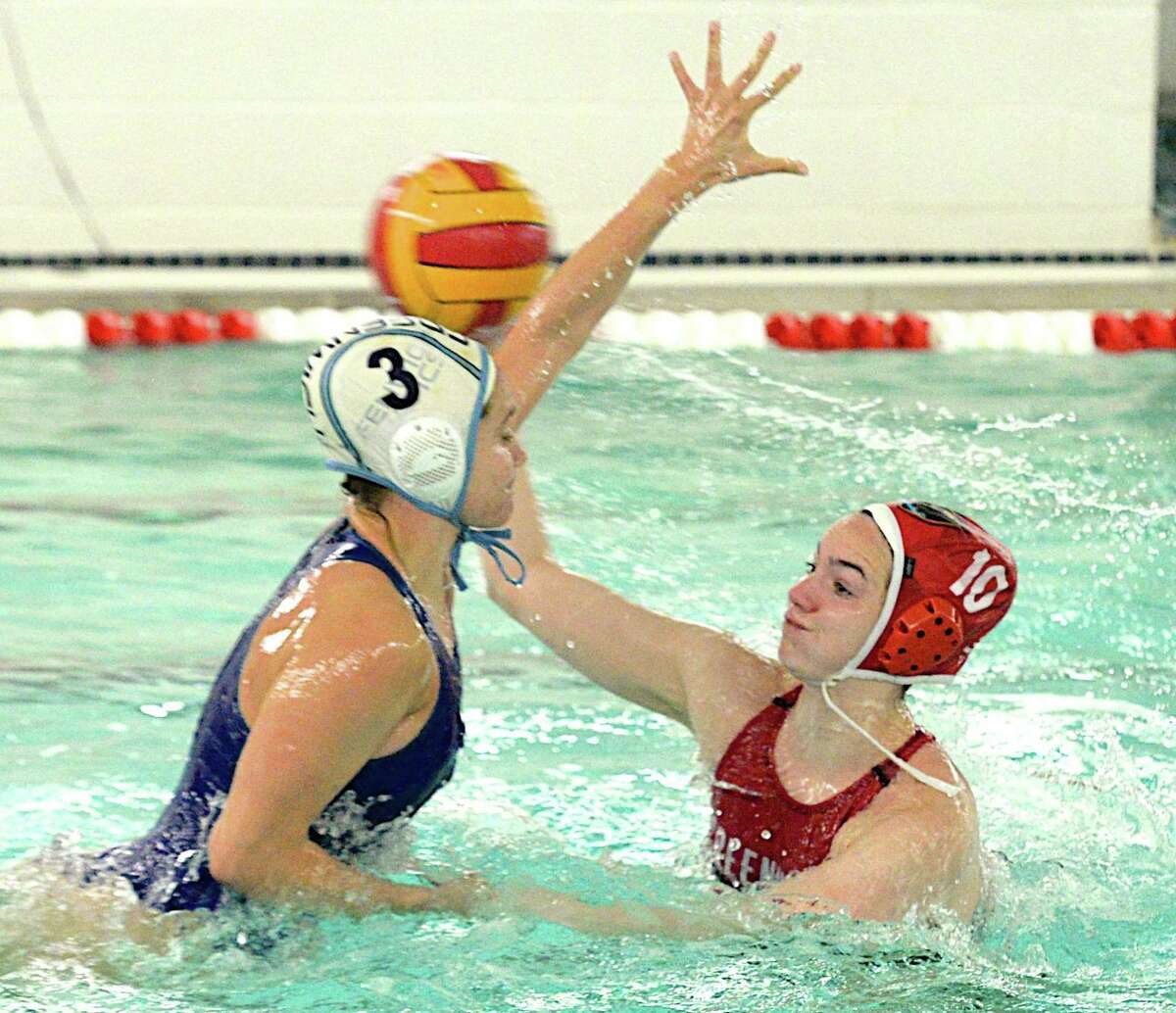 Annie Robinson of Greenwich High School, right, looks to pass the ball while being defended by Ally Furano of Greenwich Aquatics during a game at the Greenwich High School Girls Water Polo Tournament Saturday, May 12, 2017.