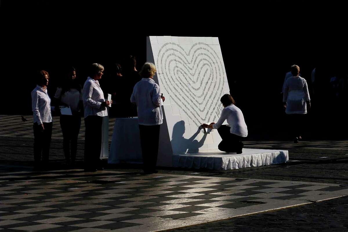 The names of the victims of the 2016 Nice attack are displayed during a ceremony in Nice, southern France, Friday, July 14, 2017. Commemorations followed Bastille Day celebrations for French President Emmanuel Macron who headed to the Riviera city of Nice for a solemn remembrance of the 86 lives lost one year ago when a 19-ton truck throttled through revelers feting France's national day in a terror attack that jolted the nation and stunned the world. (AP Photo/Laurent Cipriani)
