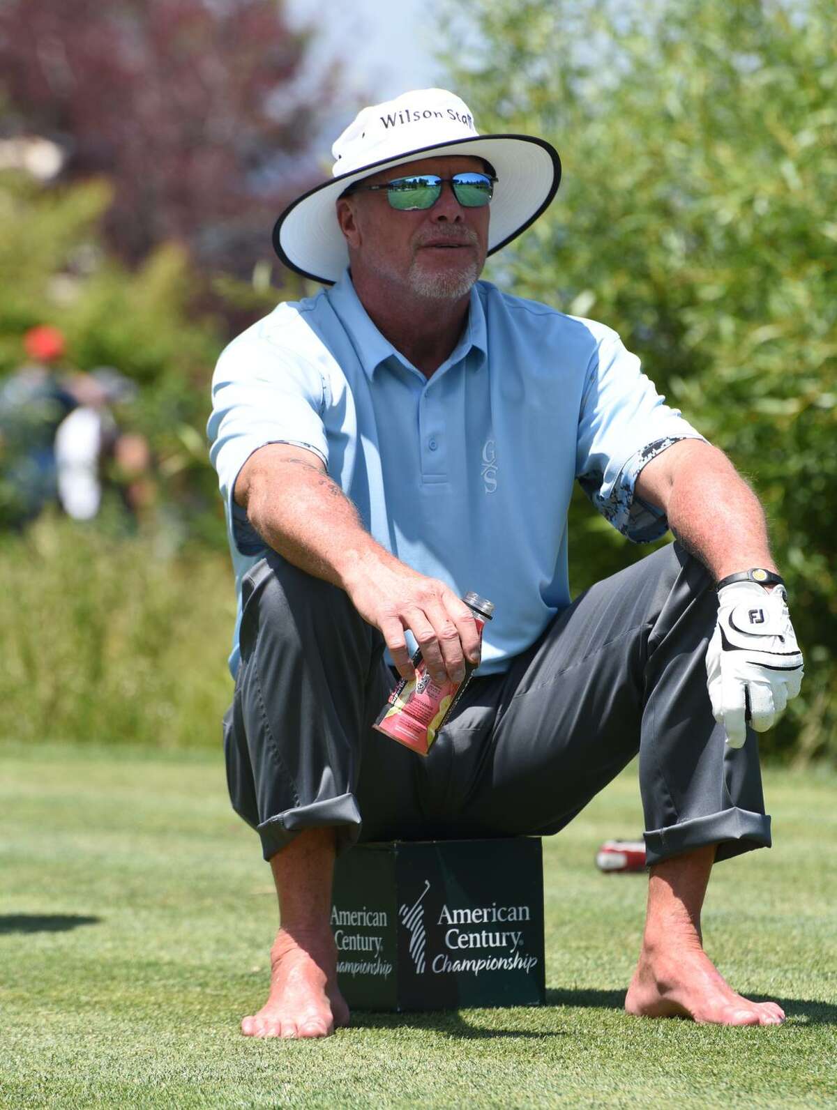A barefoot Jim McMahon plays in 60 to 70 celebrity golf tournaments a year.