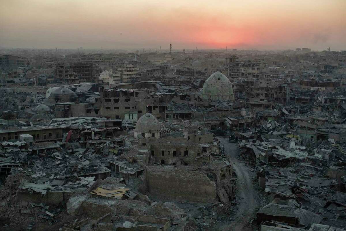 ﻿The sun sets behind destroyed buildings in ﻿western ﻿Mosul, Iraq. ﻿The fight to root out the Islamic State damaged or destroyed nearly a third of the historic Old City, and fewer than a tenth of the 730,000 people who fled western Mosul have returned.