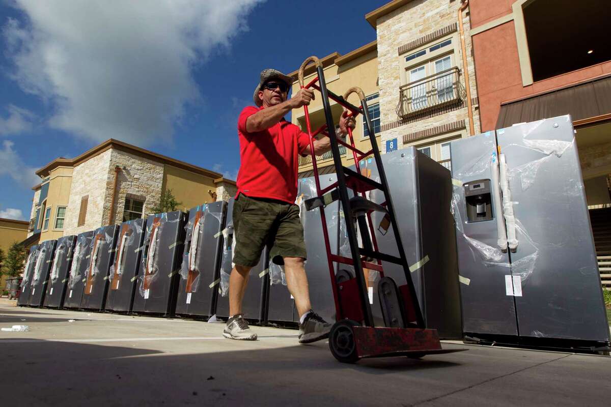 Refrigerators offloaded and lined up to be installed in apartments at The Loop Apartments on North Loop 366, Friday, July 14, 2017, in Conroe.