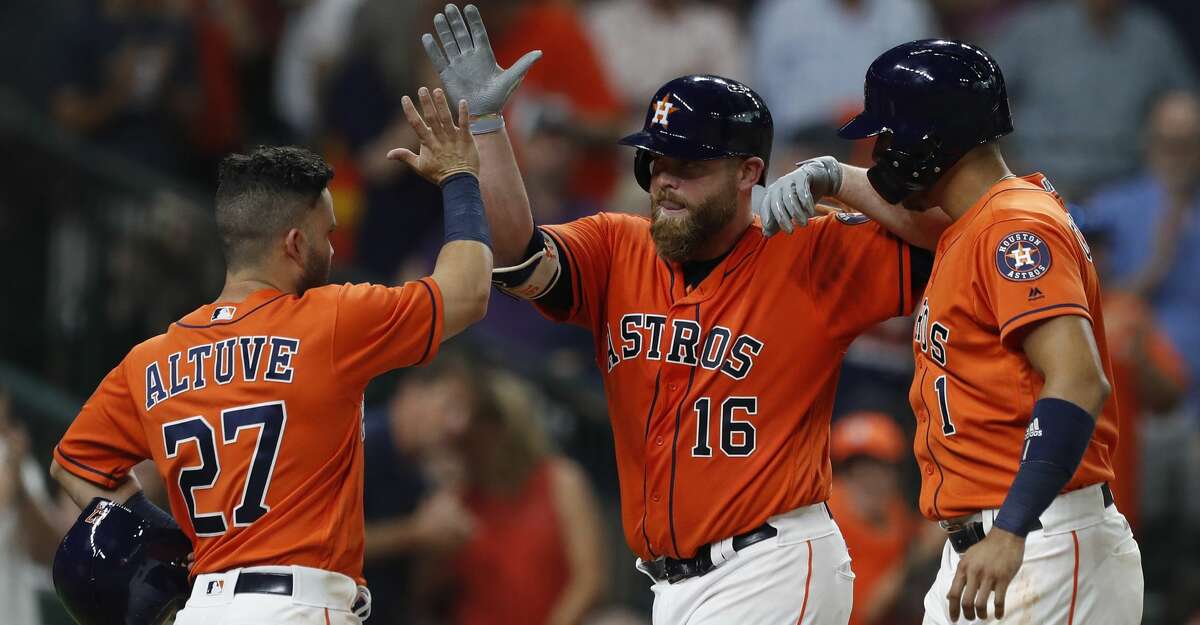 Houston Astros Brian McCann (16) celebrates his three-run home run with Jose Altuve, and Carlos Correa during the second inning of an MLB baseball game at Minute Maid Park, Friday, July, 14, 2017. ( Karen Warren / Houston Chronicle )