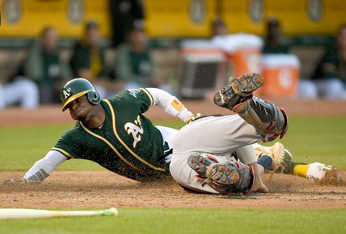 OAKLAND, CA - JULY 14: Rajai Davis #11 of the Oakland Athletics scores sliding past the tag of Yan Gomes #7 of the Cleveland Indians in the bottom of the third inning at Oakland Alameda Coliseum on July 14, 2017 in Oakland, California. (Photo by Thearon W. Henderson/Getty Images)