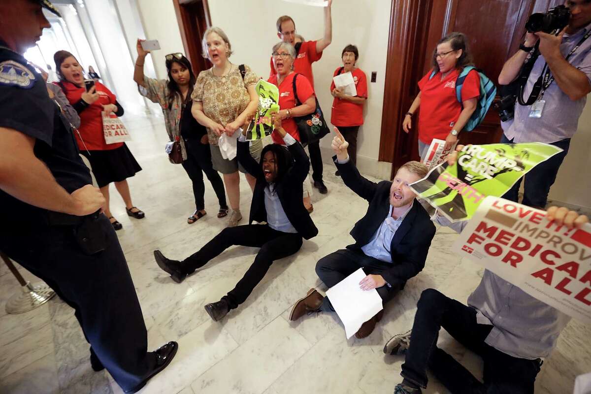 Demonstrators from Texas opposing the GOP health plan chant "Kill the bill, kill the bill" on Monday outside Cruz's office in the Russell Senate Office Building on Capitol Hill.
