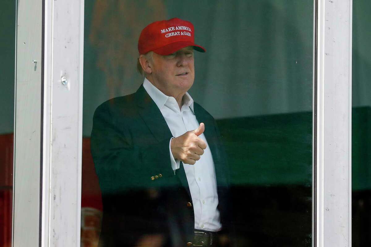 Donald Trump gives the thumbs-up from his viewing stand Saturday at the U.S. Women's Open.﻿
