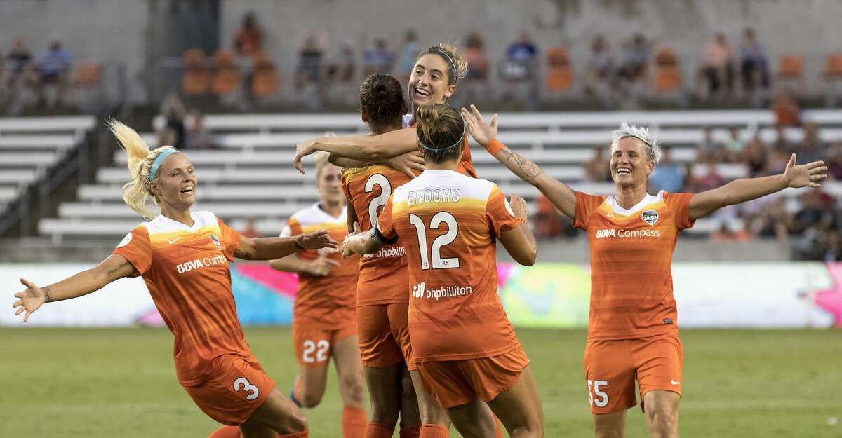 Houston Dash forward Rachel Daly (3), midfielder Amber Brooks (12), and defender Janine Van Wyk (55) celebrate with defender Poliana Barbosa Medeiros (2) after a goal in the first half during the NWSL game between the Washington Spirit and Houston Dash on Saturday July 15, 2017. The Dash lead the Spirit 1-0.