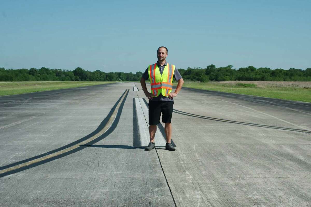 Pearland Regional Airport operations manager Adam Arceneaux stands on the main runway of the facility, which is slated for improvements using a $500,000 grant from the Federal Aviation Administration.