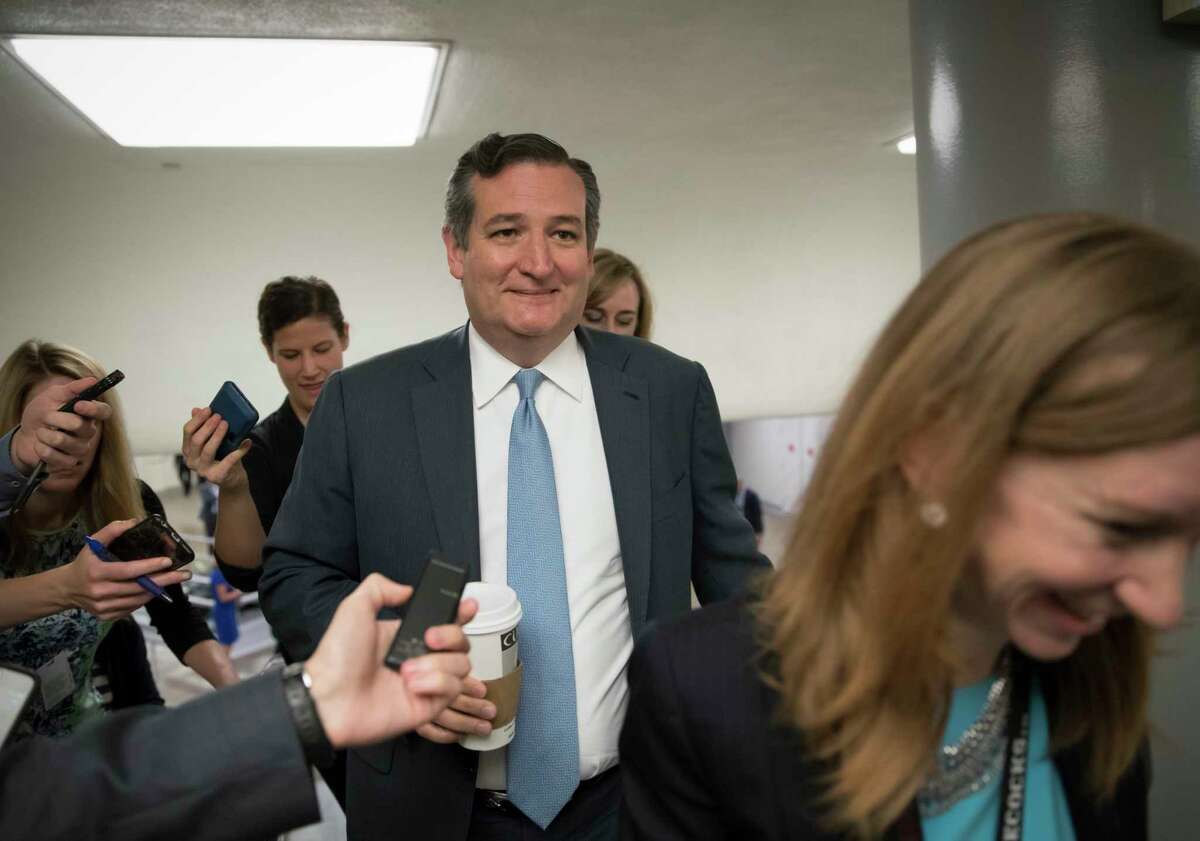 Sen. Ted Cruz, R-Texas, and other lawmakers head to the Senate on Capitol Hill in Washington, Thursday, July 13, 2017, for a meeting on the revised Republican health care bill which has been under attack from within the party. (AP Photo/J. Scott Applewhite)