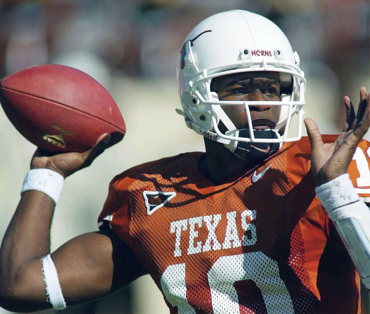 FILE - In a Oct. 16, 2004 file photo, Texas quarterback Vince Young looks for a receiver during the second quarter of Texas' 28-20 victory over Missouri in Austin, Texas. When the Big 12 kicks off its football media days on Monday, July 17, 2017, commissioner Bob Bowlsby will be able to tout a winning record in bowl games last season and the still-growing revenue for the leagueÂ?’s 10 schools. What the league really needs this season is to get a team into the College Football Playoff. (AP Photo/Harry Cabluck, File)