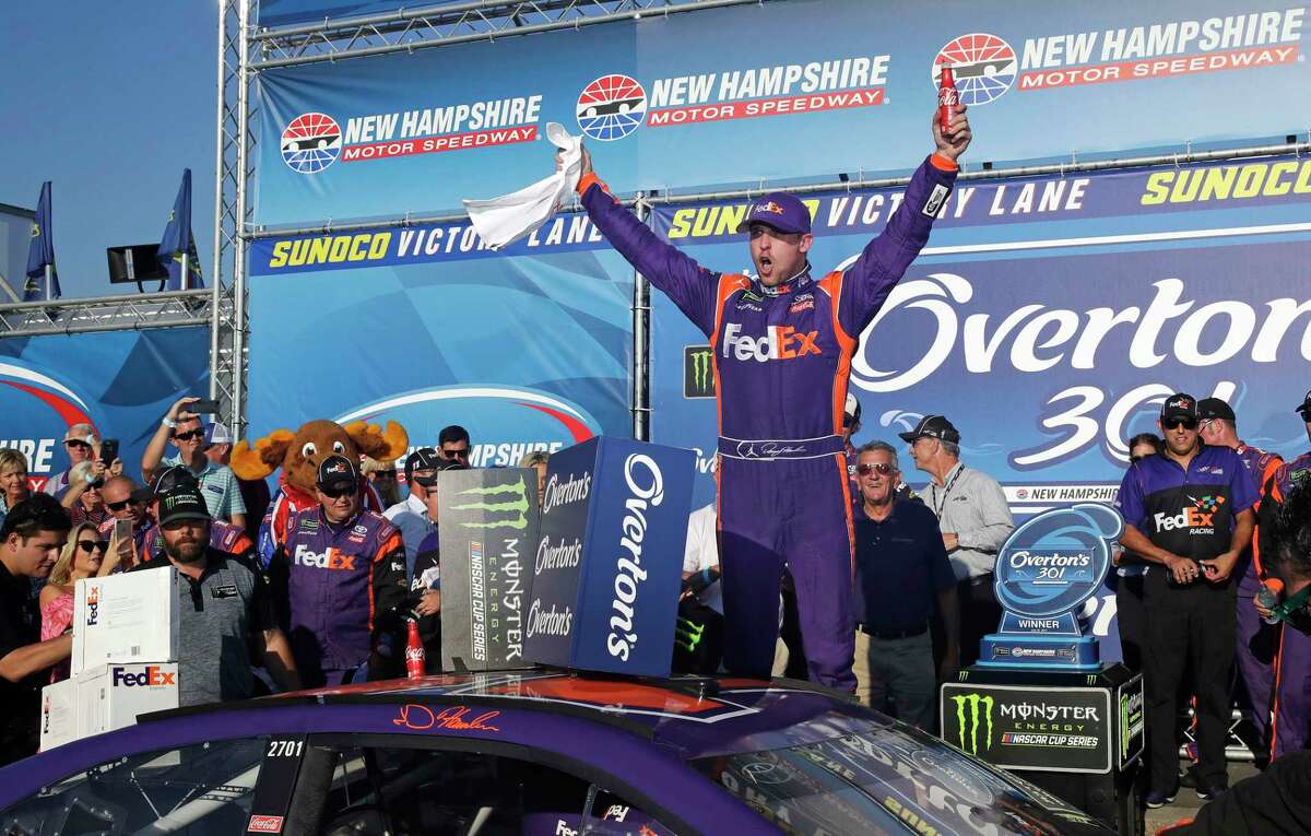Driver Denny Hamlin celebrates after winning the NASCAR Cup Series 301 auto race at the New Hampshire Motor Speedway in Loudon, N.H., Sunday.