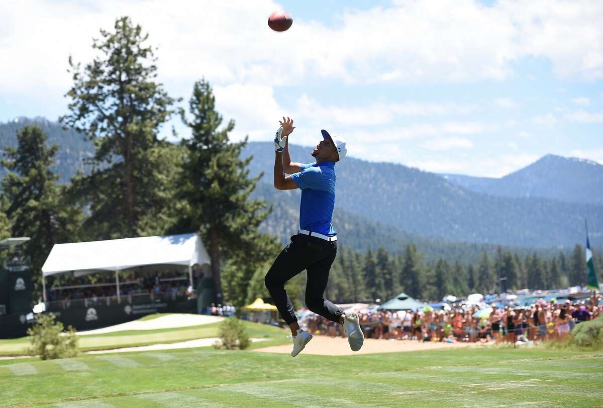 Stephen Curry catches a long pass from Tony Romo on the 17th Fairway of the American Century Championship in Stateline Nevada on Sunday July 16, 2017.