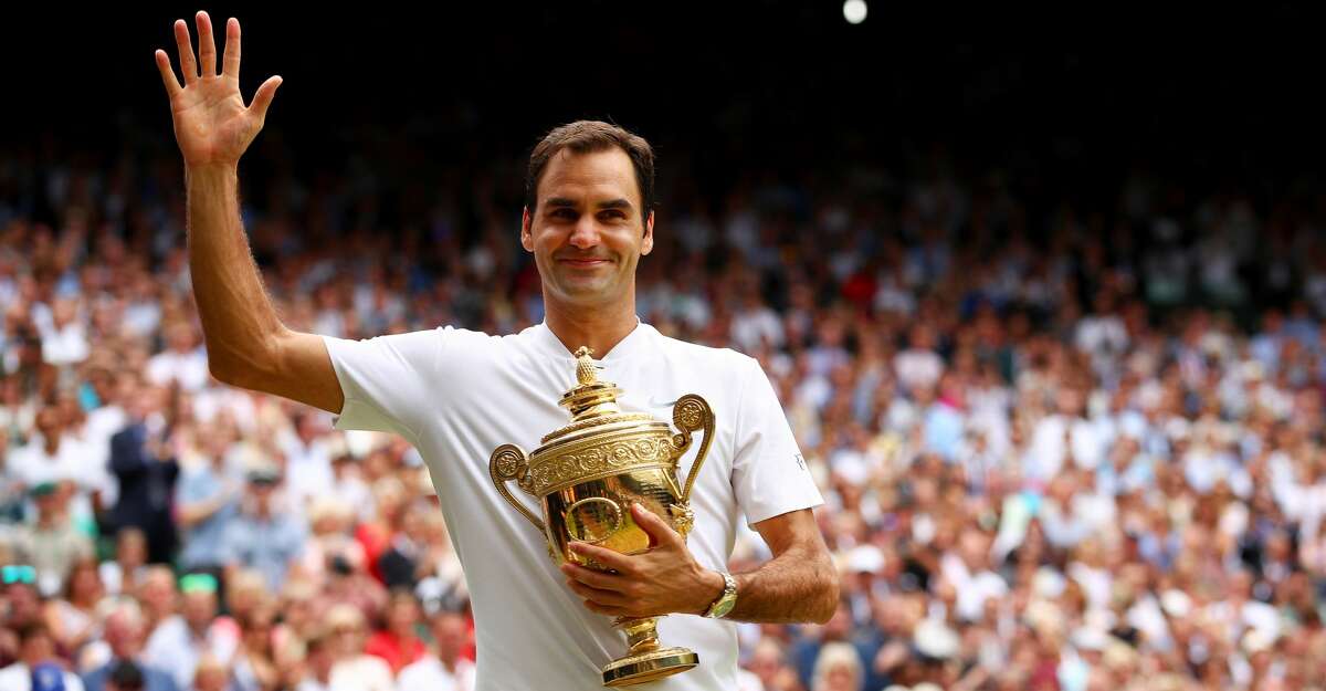 LONDON, ENGLAND - JULY 16: Roger Federer of Switzerland celebrates victory with the trophy after the Gentlemen's Singles final against Marin Cilic of Croatia on day thirteen of the Wimbledon Lawn Tennis Championships at the All England Lawn Tennis and Croquet Club at Wimbledon on July 16, 2017 in London, England. (Photo by Clive Brunskill/Getty Images)
