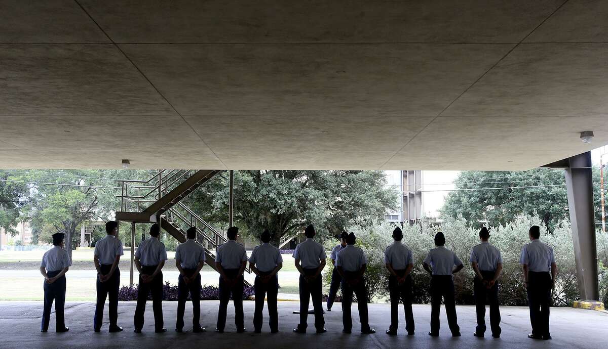 Air Force trainees line up Thursday July 13, 2017 under what is called an overhang at one of Lackland Air Force Base's older dorm buildings built in the early 1970s. The Air Force’s Air Education and Training Command is mapping construction plans that is calling for modernization of key facilities such as dormitories.