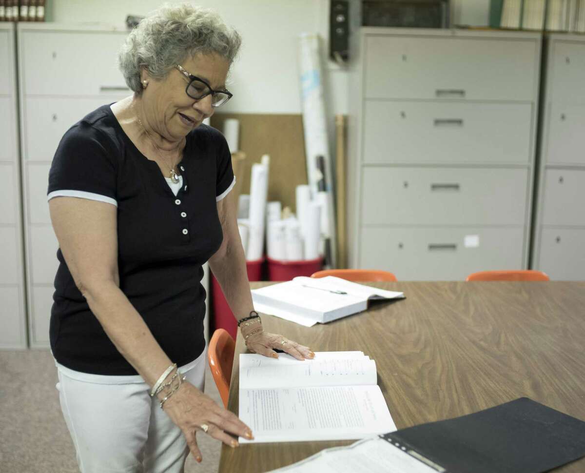 Yolanda Patino looks at a 1772 record of the trial of Juan de Sosa on July 8, 2017, at Los Bexarenos Genealogical and Historical Society in San Antonio. The organization was started by Gloria V. Cadena.