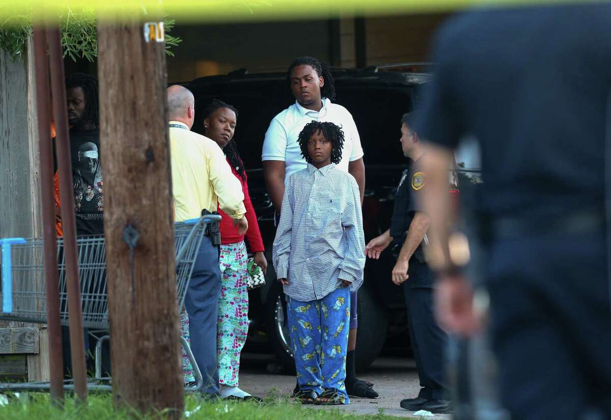 Houston Police talk to the family of the 14-year-old boy who was shot in the 100 block of Goodson Drive on Monday, July 17, 2017, in Houston. The boy died at a hospital.