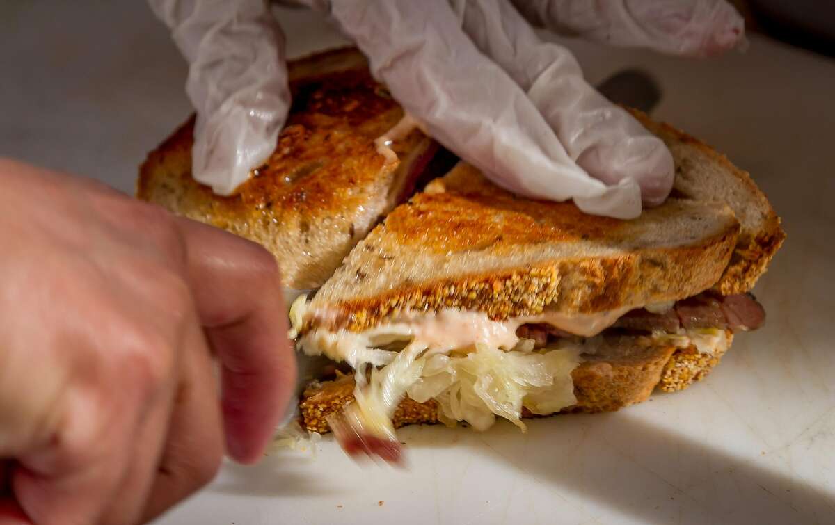 A Reuben sandwich being cut at Wise Sons Deli in the Contemporary Jewish Museum in San Francisco, Calif., is seen on December 27th, 2013.