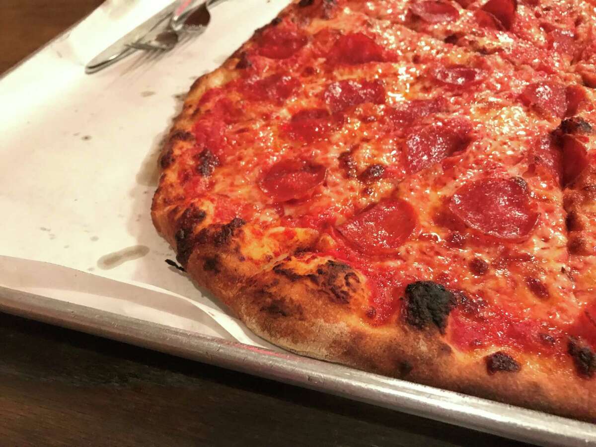A tomato, mozzarella, and pepperoni pizza at Sally's Apizza, 237 Wooster St., in New Haven, CT.