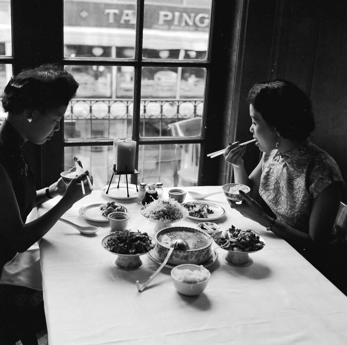 circa 1955: Two women sample the bird's nest soup and other delicacies on offer at Johnny Kan's famous Chinese restaurant in Chinatown, San Francisco. (Photo by Orlando /Three Lions/Getty Images)