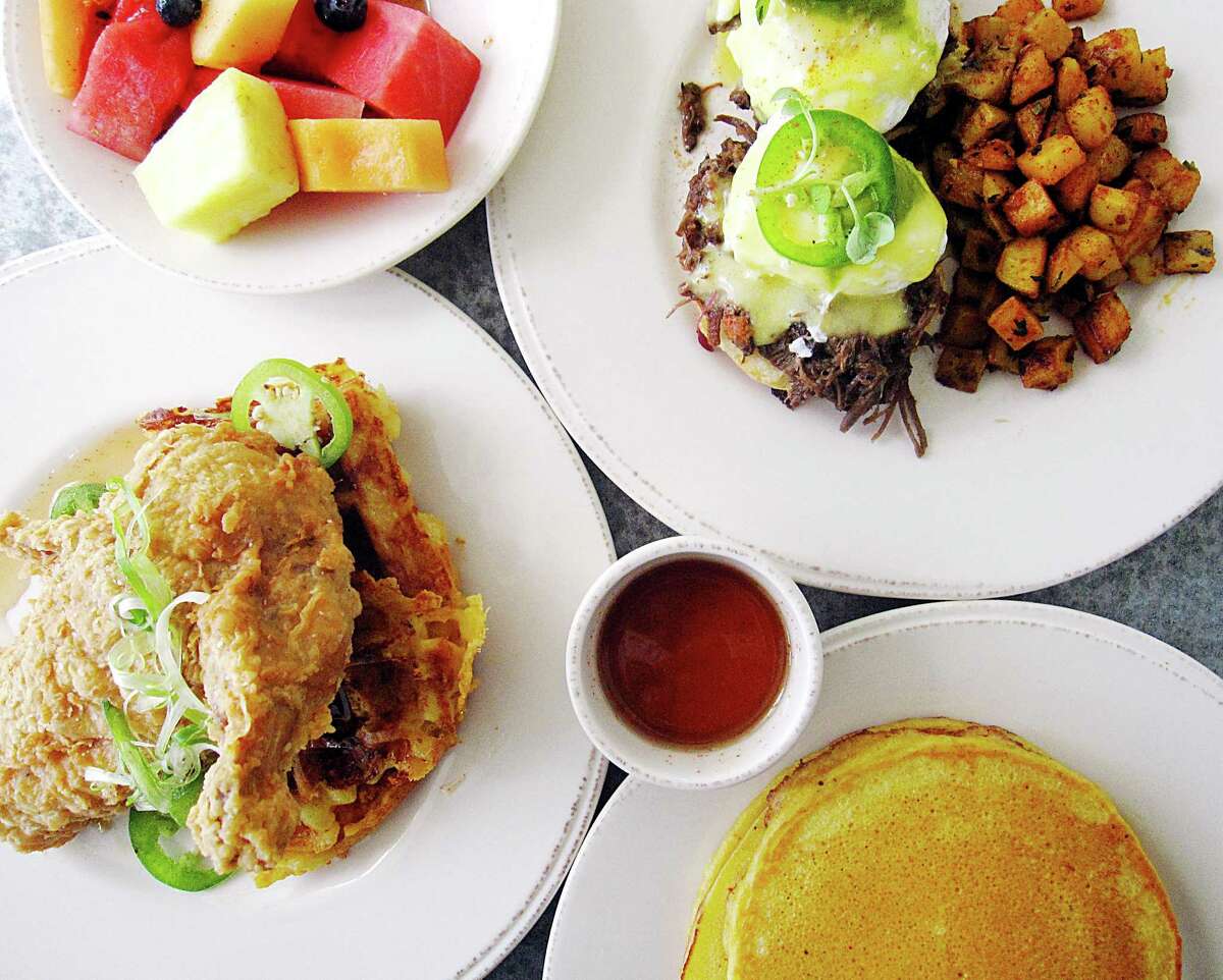Dishes from the Sunday brunch menu at Peggy's on the Green, clockwise from left: Fried chicken with mac and cheese "waffles," fruit, short rib Benedict and pancakes