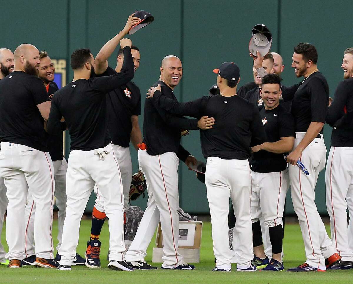 HOUSTON, TX - JULY 17: Carlos Beltran (C) reacts with his teammates after a funeral was held in center field for his glove since he hasn't played the outfield since May 16 at Minute Maid Park on July 17, 2017 in Houston, Texas.