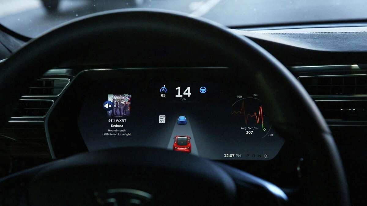 The dashboard of the Tesla Model S P90D shows the icons enabling Tesla's autopilot, featuring limited hands-free steering, making the Tesla the closest thing to an autonomous-driving enable vehicle.