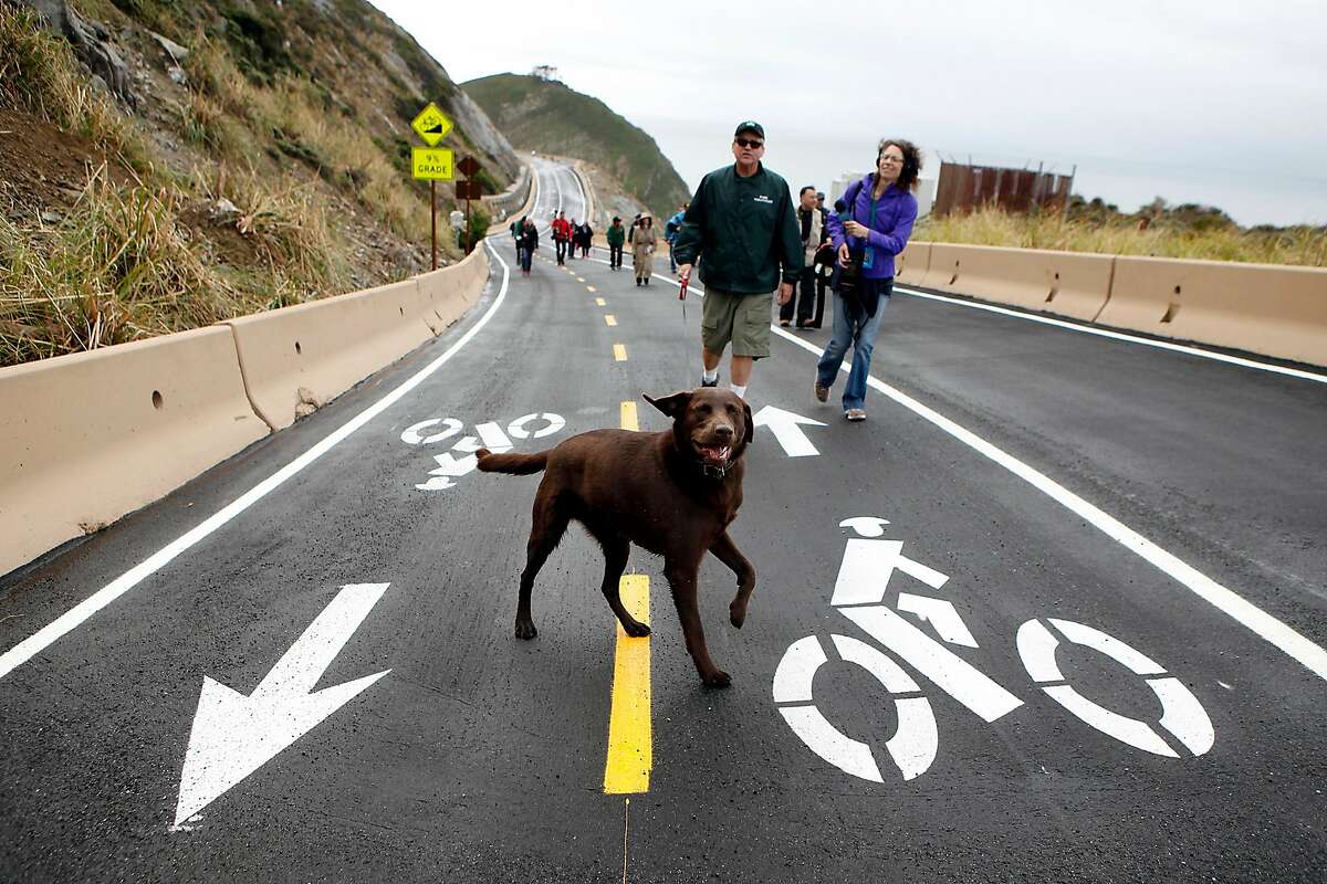 Park ambassador Don Traeger walks with his dog Maverick during a media tour of the newly completed Devil's Slide Costal Trail in Montara, CA, Tuesday Mar. 25, 2014.