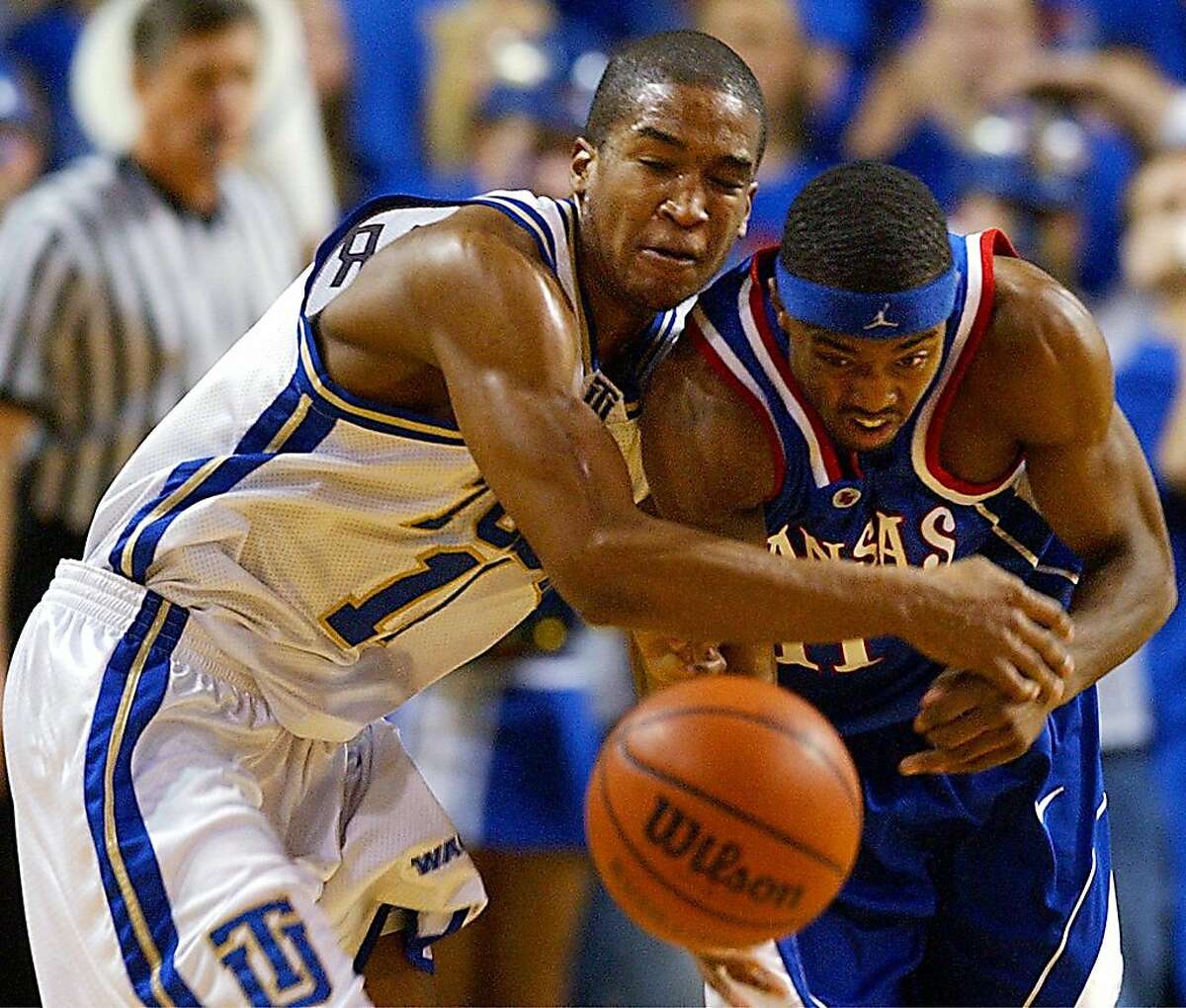 Tulsa's Jason Parker, left, fights for the ball with Kansas' Aaron Miles during the first half Wednesday, Dec. 11, 2002, in Tulsa, Okla. (AP Photo/Tulsa World, Stephen Pingry)