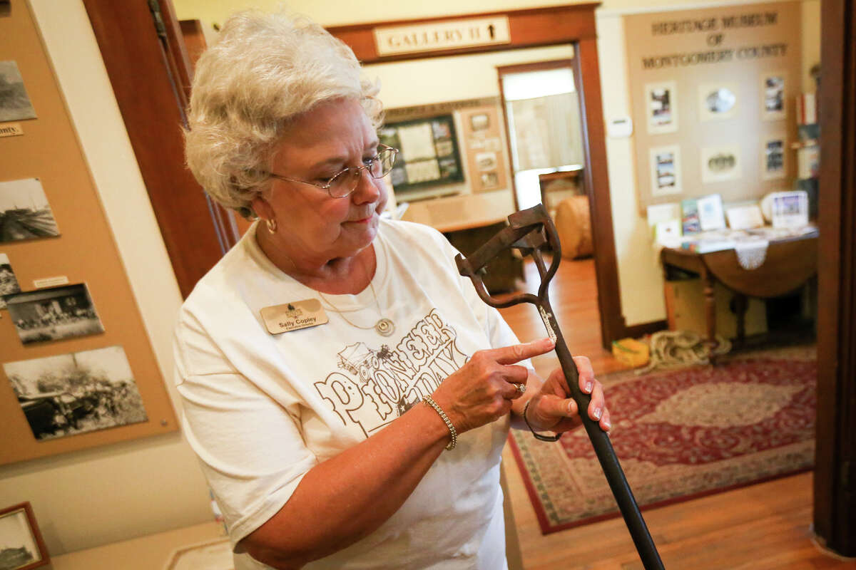 Heritage Museum Executive Director Sally Copley points out a numbered label on one of their branding poles, similar to a couple of the antique tools that were stolen on July 10, at the Heritage Museum of Montgomery County on Tuesday, July 18, 2017.