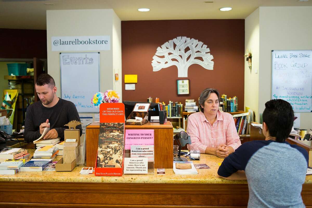 Luan Stauss, second from right, gives book suggestions to Joanne Mulson at Laurel Book Store in Downtown Oakland, Calif. on Tuesday, July 18, 2017. Lauren Stauss has struggled to keep her bookstore in the historic flatiron building open and is afraid it may close.
