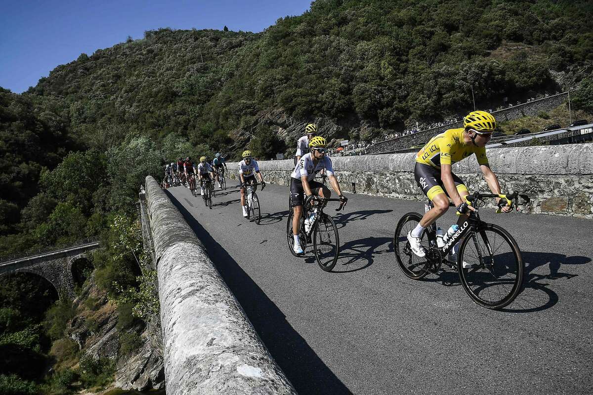Great Britain's Christopher Froome (R), wearing the overall leader's yellow jersey, rides on a bridge ahead of his teammate Spain's Mikel Landa (2ndR) during the 165 km sixteenth stage of the 104th edition of the Tour de France cycling race on July 18, 2017 between Le Puy-en-Velay and Romans-sur-Isere. / AFP PHOTO / Lionel BONAVENTURELIONEL BONAVENTURE/AFP/Getty Images
