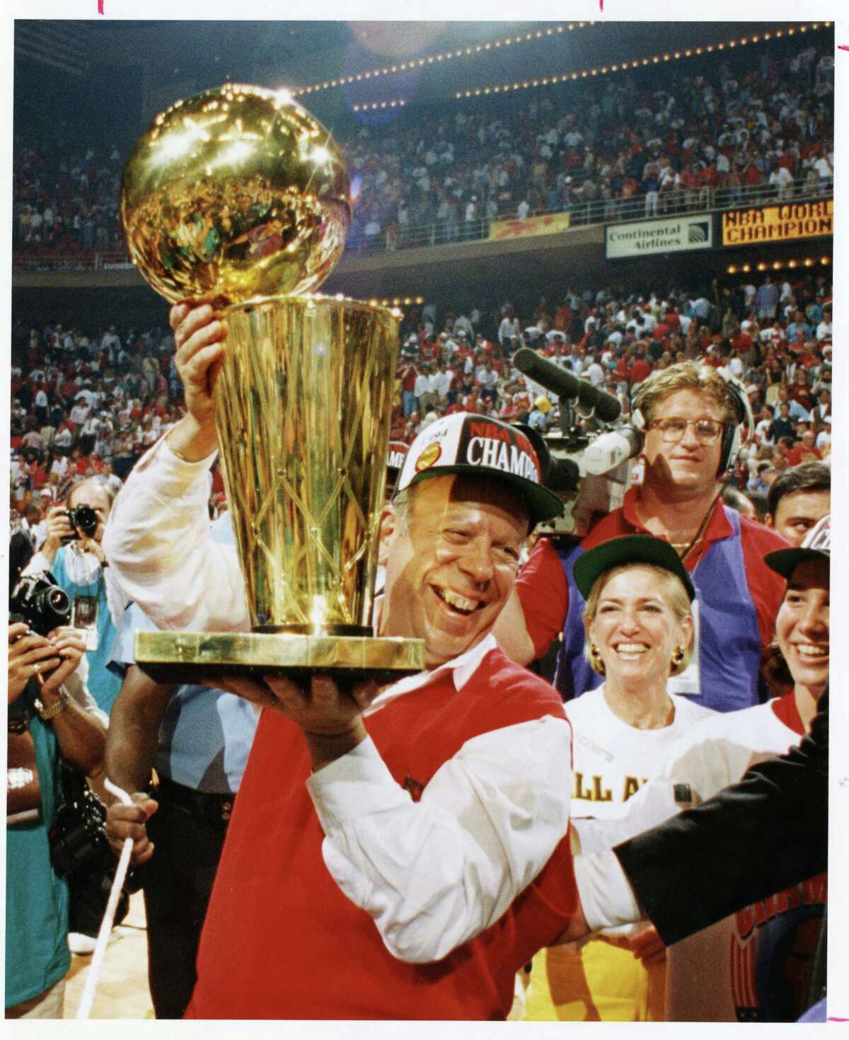 Owner Leslie Alexander clutches the trophy after the Rockets beat the Knicks in 1994 for the NBA title. (Houston Chronicle file)