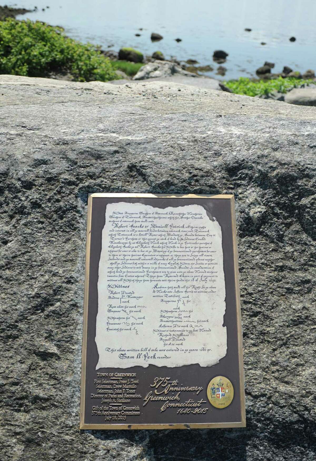 A new bronze replica of the original town deed is displayed on a rock at Tod’s Point.