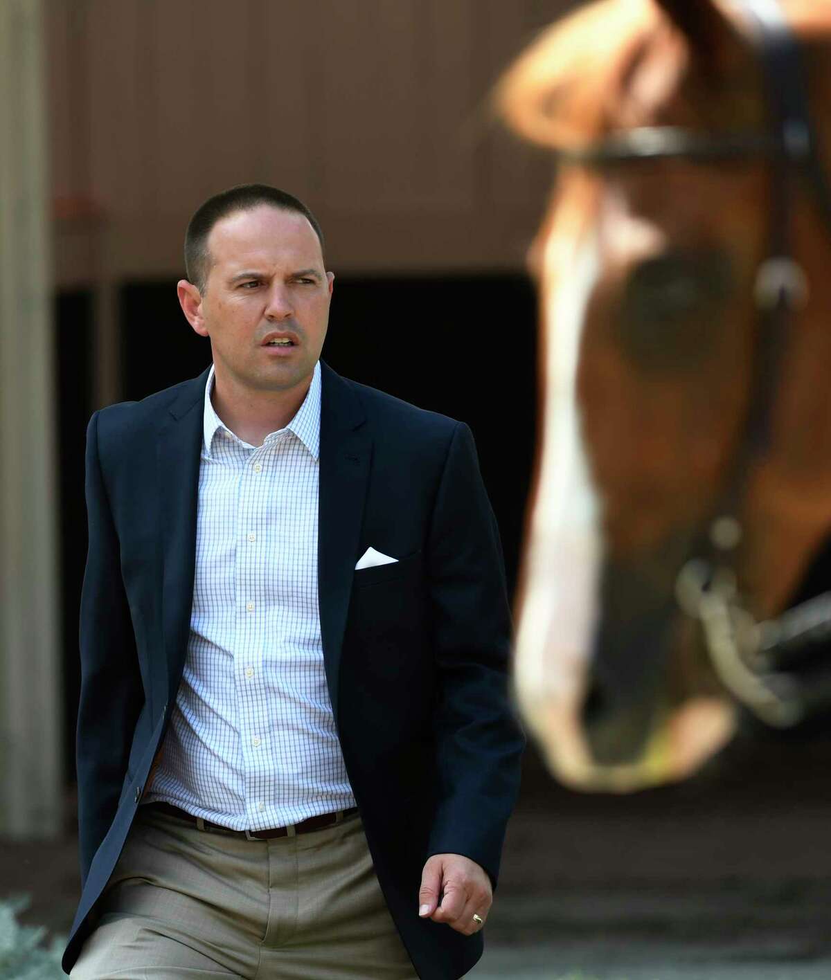 Trainer Chad Brown leaves the paddock after saddling his charge at the Saratoga Race Course Wednesday July 27, 2016 in Saratoga Springs, N.Y. (Skip Dickstein/Times Union)