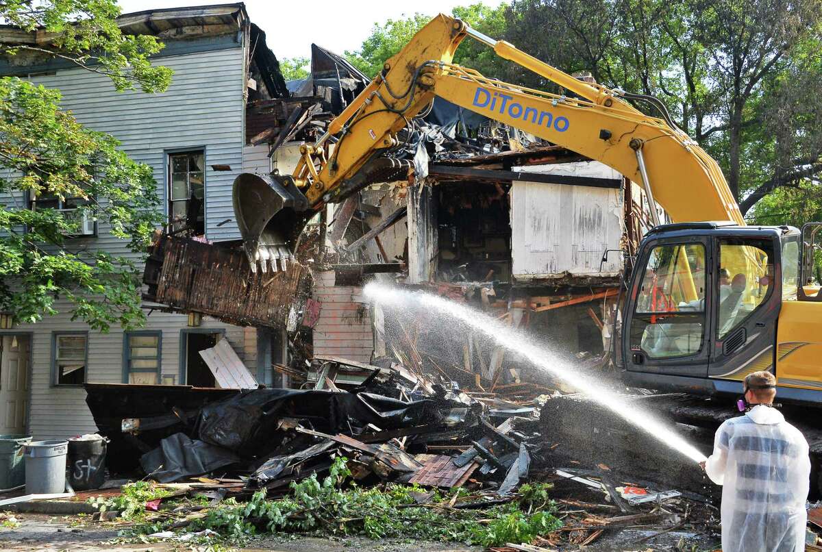 Demolition crews make short work of four historic row houses damaged by an overnight fire on the 400 block of Madison Avenue Tuesday July 18, 2017 in Albany, NY. (John Carl D'Annibale / Times Union)