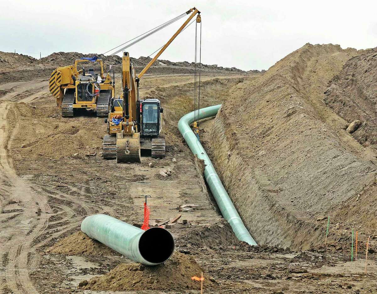 FILE - In this Oct. 5, 2016, file photo, heavy equipment works at a site where sections of the Dakota Access pipeline are being buried near the town of St. Anthony in Morton County, N.D. The Army Corps of Engineers says additional environmental review of the already-operating pipeline ordered by a judge in June 2017 is likely to take the rest of the year. (Tom Stromme/The Bismarck Tribune via AP, File)