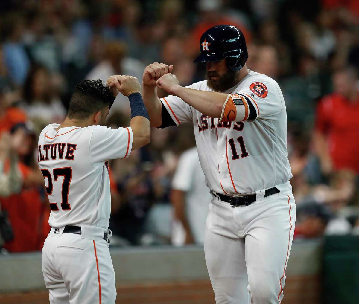 The long and short of it for the Astros' offense Tuesday night were Jose Altuve, left, who had three singles, and Evan Gattis, here receiving congratulations from his diminutive teammate after hitting the first of two homers in the second.