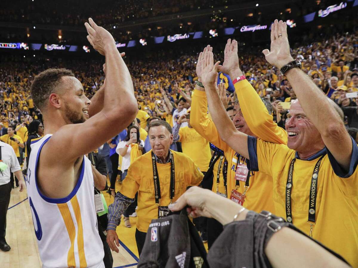 Stephen Curry celebrates with fans at Oracle Arena after the Warriors won Game 5 of the NBA Finals against Cleveland to regain the NBA championship.
