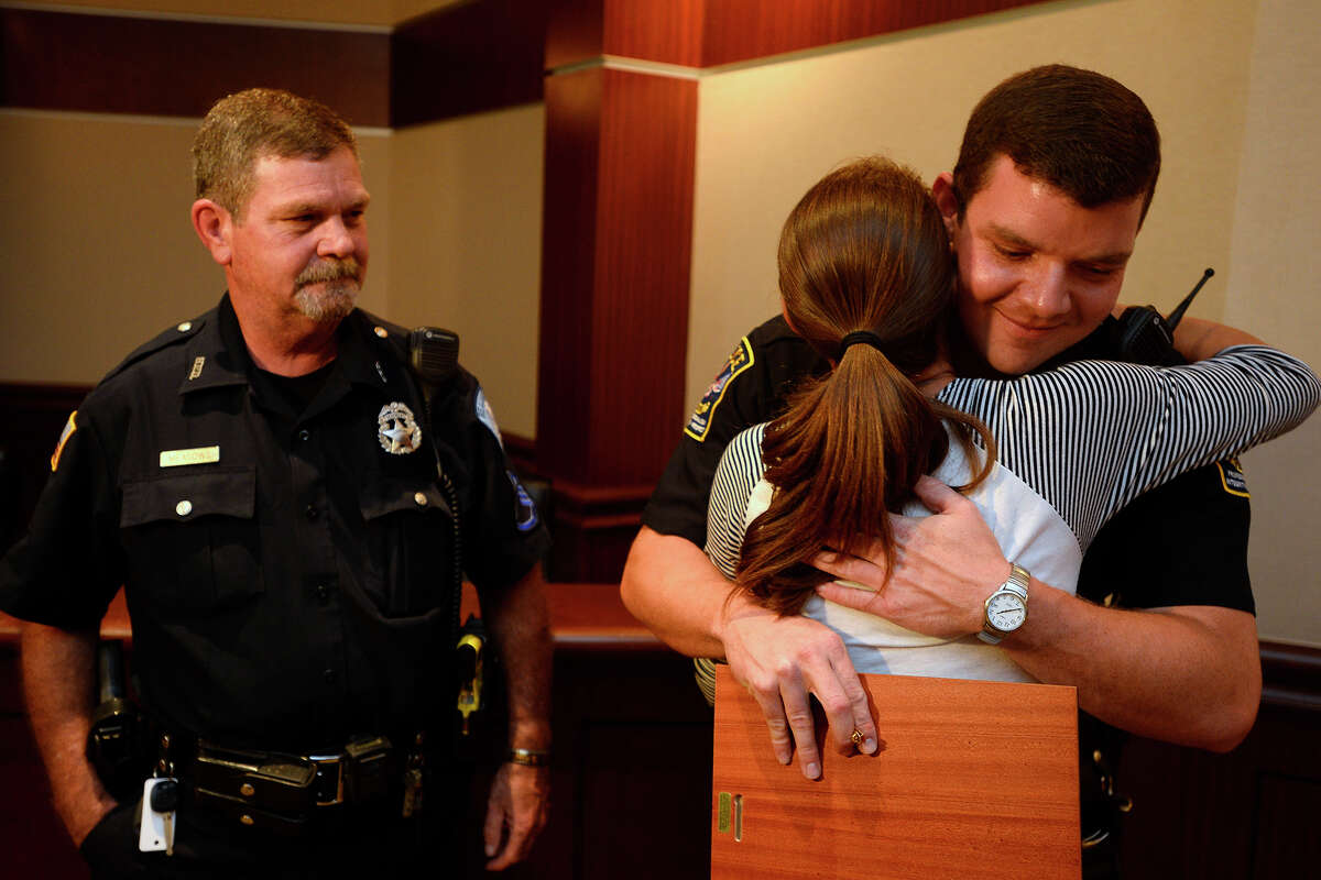 Ashley Ninteman thanks Vidor Police Officer Tom Meadows after an award ceremony at Vidor City Hall on Wednesday. Loredo and five other Vidor police officers and several civilians helped rescue victims from a car that had crashed into the water on June 30. Ninteman's brother, Jonathan, survived the wreck that killed another in the car. Photo taken Wednesday 7/19/17 Ryan Pelham/The Enterprise