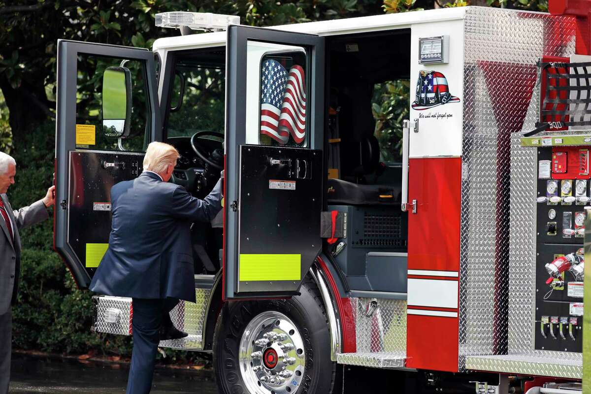 President Donald Trump climbs into a Pierce firetruck during a "Made in America," product showcase featuring items created in each of the U.S. 50 states, at the White House, Monday, July 17, 2017, in Washington. (AP Photo/Alex Brandon)