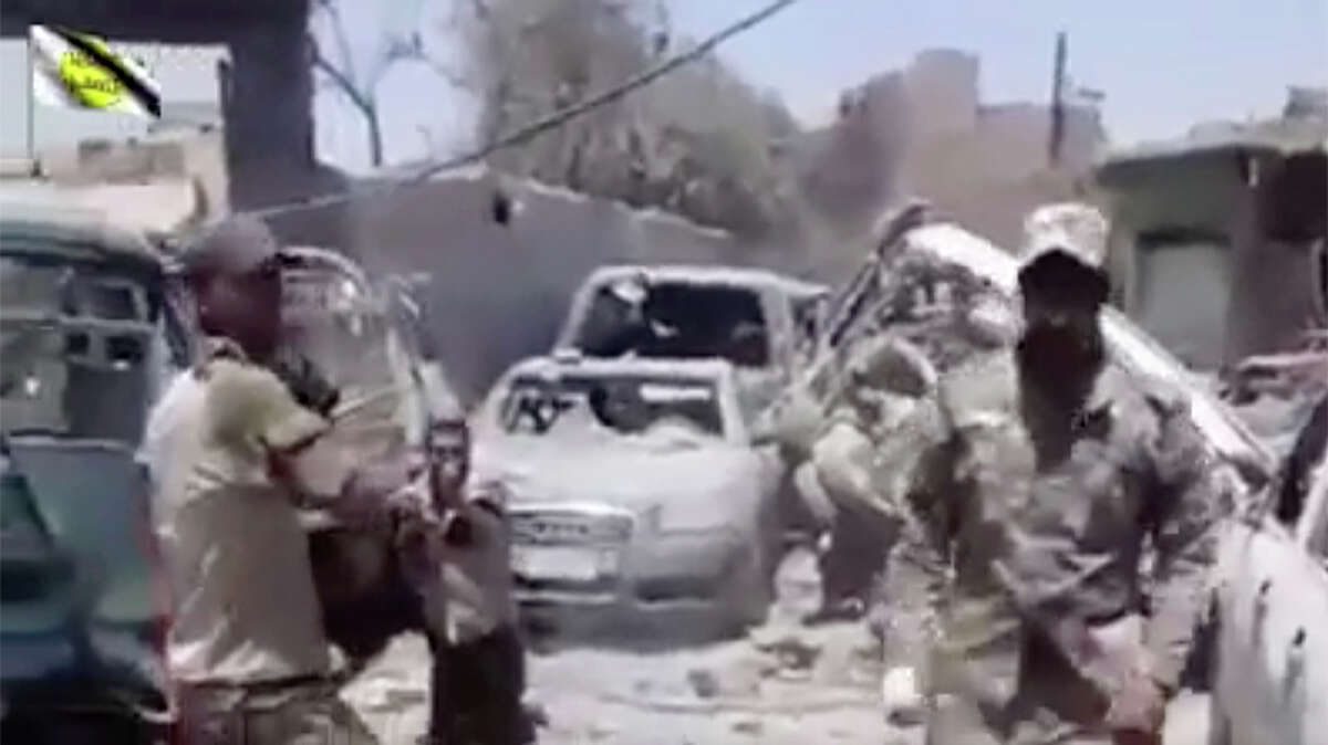 FILE - This file photo made from undated video posted online in July, 2017 shows a man in an Iraqi Army uniform moments before shooting an unarmed man in Mosul, Iraq. Vengeance is fueling a string of extrajudicial killings of Islamic State group militants amid the fall of Mosul. One Iraqi lieutenant says he has been hunting the past three years for the two IS members he believes killed his father, and he describes interrogating one man and then shooting him. A video shows troops throwing IS suspects to their deaths. Rights groups warn that such killings will only fuel recruitment for the next-generation militant group.(AP Photo, File)