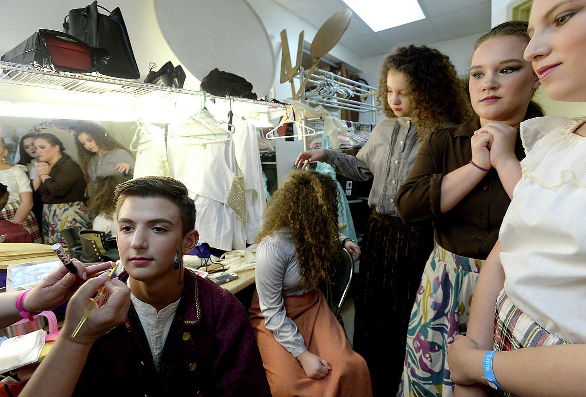 Carson Lewis, 14, patiently sits as he gets his make-up done by Kellty Jeffcoat as fellow cast members look on while prepping backstage for the Beaumont Community Players' KIDmunity TROUPE's dress rehearsal for their upcoming production of "Beauty and the Beast" at the Betty Greenberg Center for Performing Arts Wednesday. Directed by DeeDee Howell, the popular Disney tale will run Thursday through Saturday at 7 p.m., and include a 2 p.m. matinee performance Saturday. Photo taken Wednesday, July 19, 2017 Kim Brent/The Enterprise