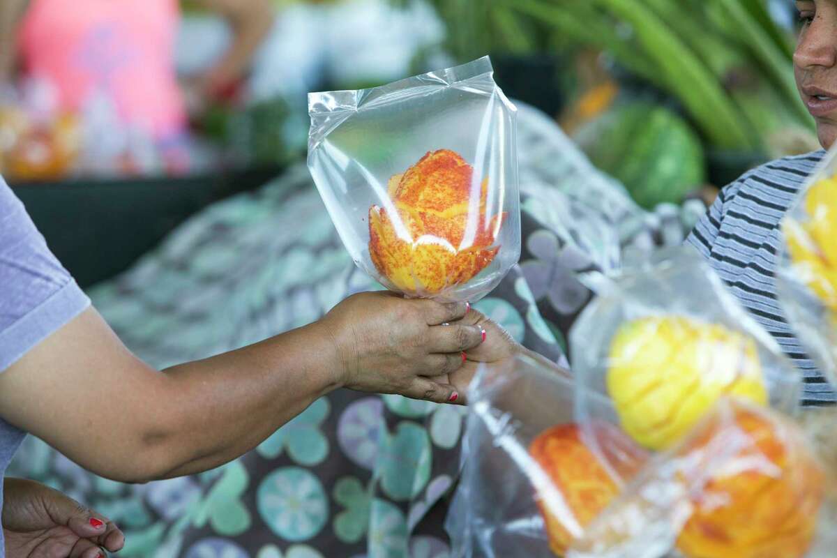Shoppers buy fruit at the farmer's market in the 2500 block of Arline on Monday, May 1, 2017, in Houston. A local developer is under contract to purchase the farmer's market property in the Heights area. The group says the market will stay, but improvements are planned that will affect the property in the long term. ( Brett Coomer / Houston Chronicle )